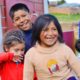 tribal college child care and welfare: happy native american children outside building