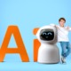 YLeveragig AI in esucation: Young, dark-haired boy in white t-shirt and blue jeans stands next to small, round-heded white robot that is as tall as the boy's shoulder. Orange letters "AI" as large as the robot are behind both of them. All against a plain sky blue backdrop and floor.