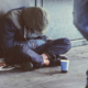 Youth Homelessness Prevalence Research Grant; young homeless man sitting on street with head down